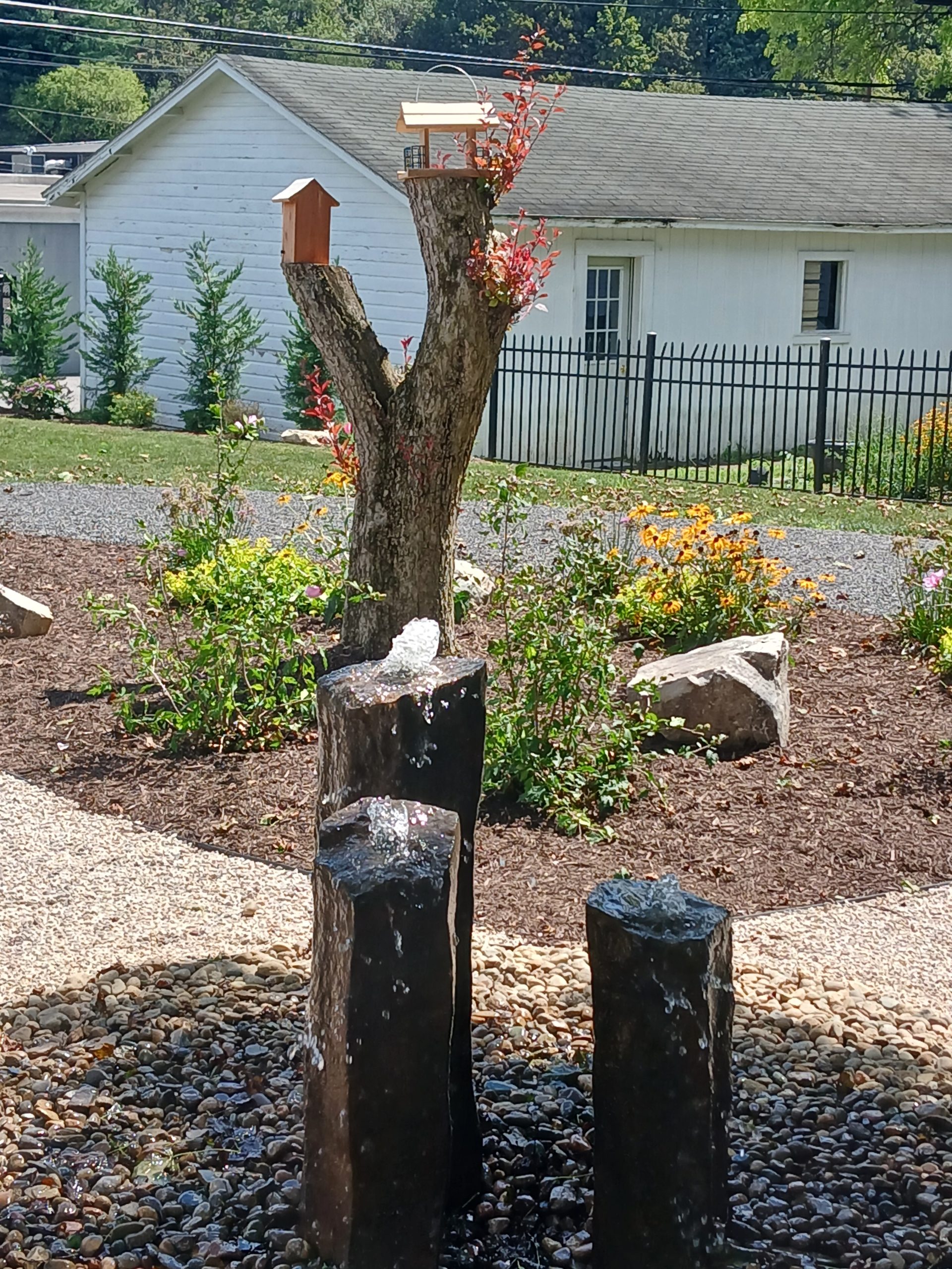 Basalt water feature with background bird feeders